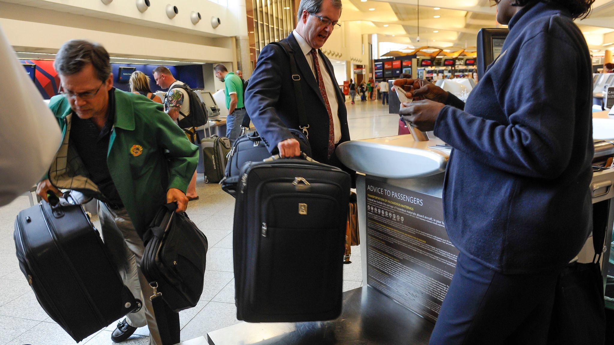 Passengers check in luggage at the Delta counter at Hartsfield-Jackson Atlanta International Airport.