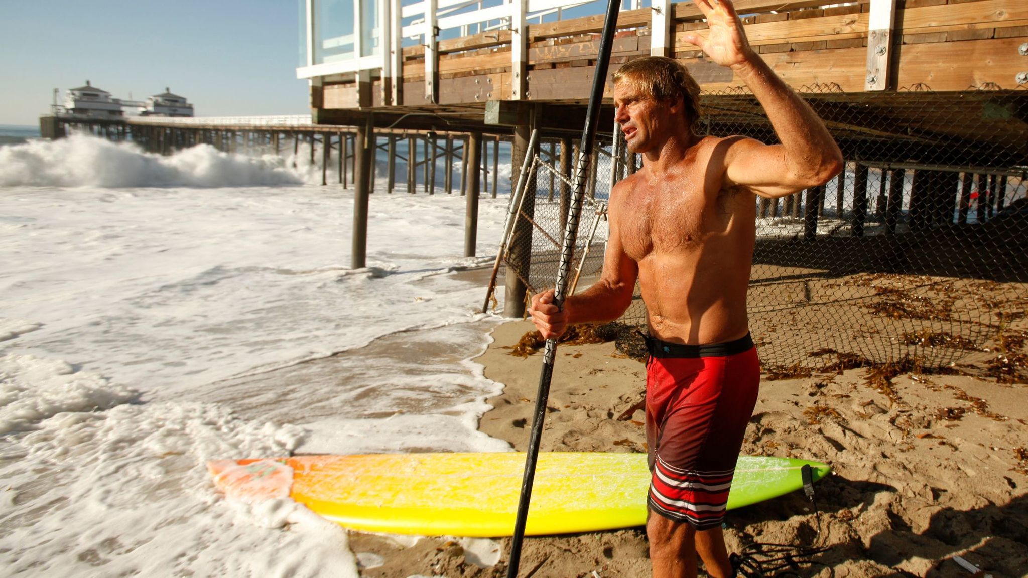 Renowned surfer Laird Hamilton prepares his standup paddle board in Malibu in this 2014 file photo.
