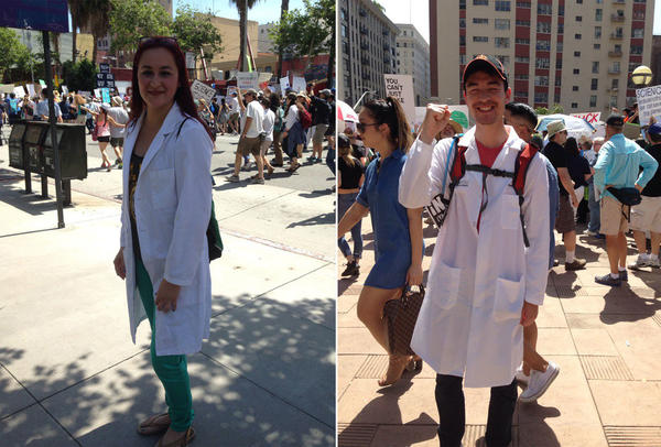 Kimberly Prado, left, and Morgan Hatch donned the lab coats they wear to work for the L.A. March for Science. (Deborah Netburn / Los Angeles Times)