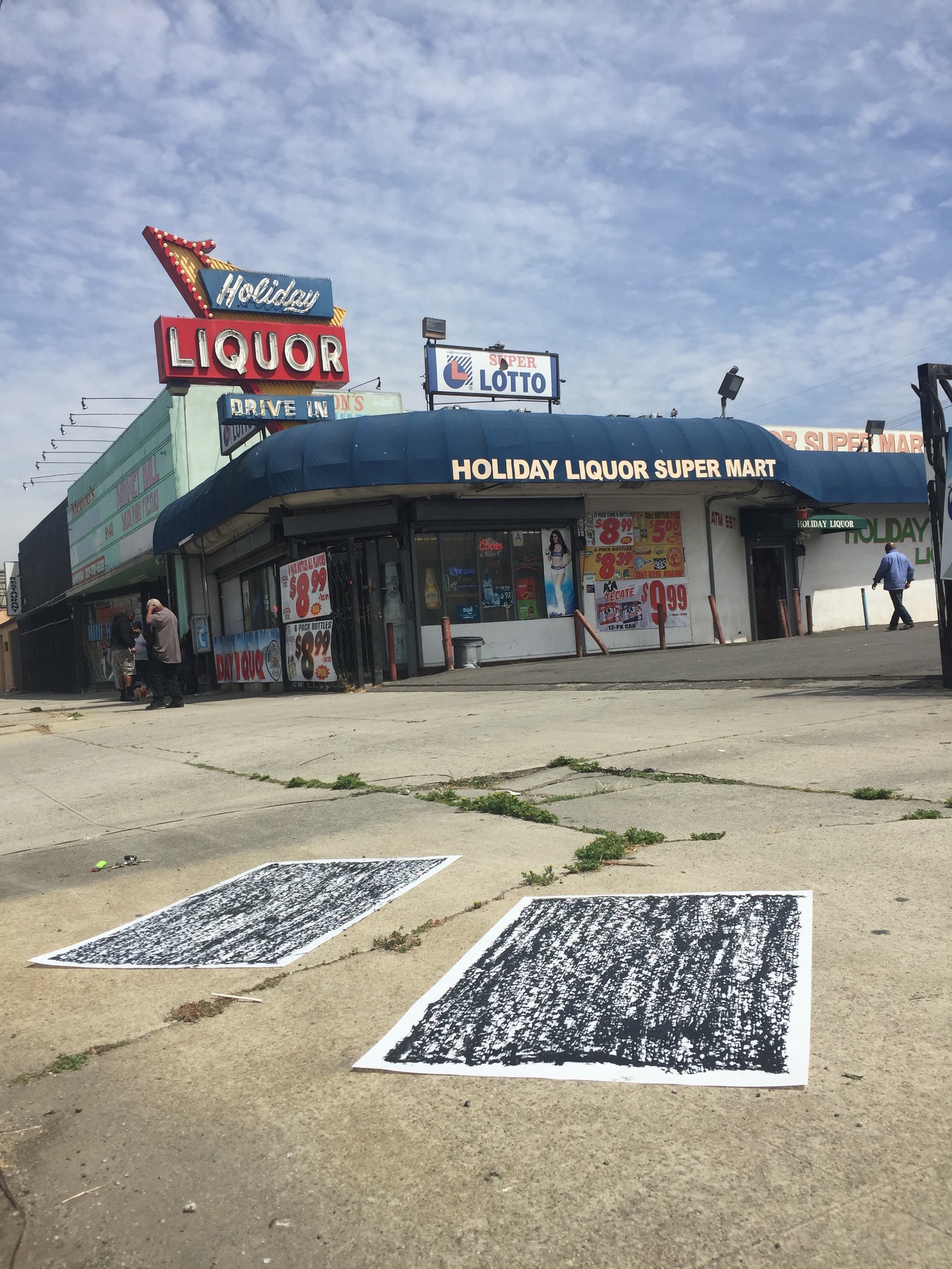 A portrait of a pair of rubbings by Jeff Beall mark the site on Western Avenue and 92nd Street where Ernest Neal Jr. and Elbert O. Wilkins, two black men, were shot to death in 1992.