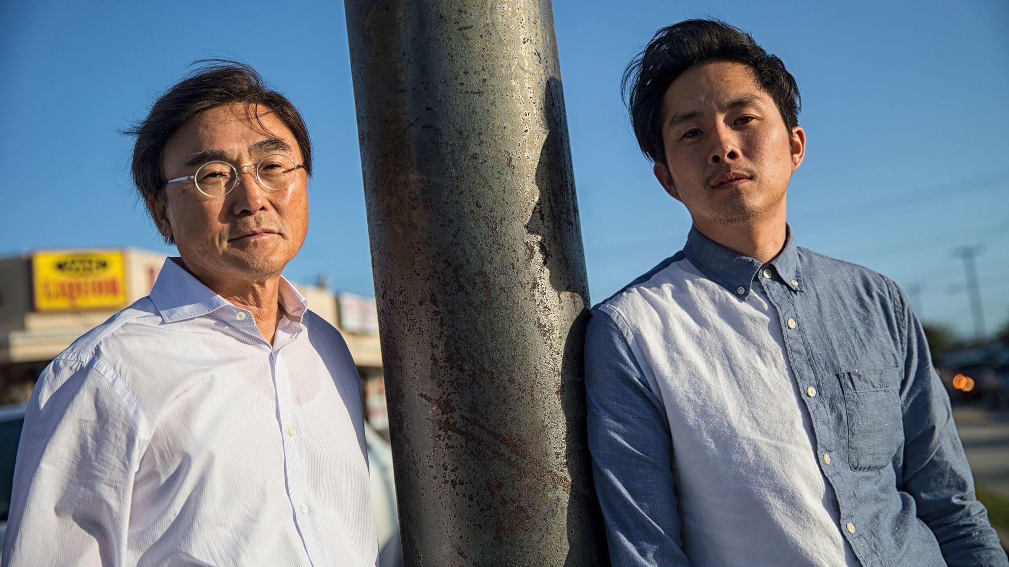 Justin Chon, right, and his father Sang Chon at the corner of Van Ness Avenue and W. Rosecrans Ave., one of the sites where Justin filmed the movie "Gook," about the Korean experience in the LA riots of 1992.