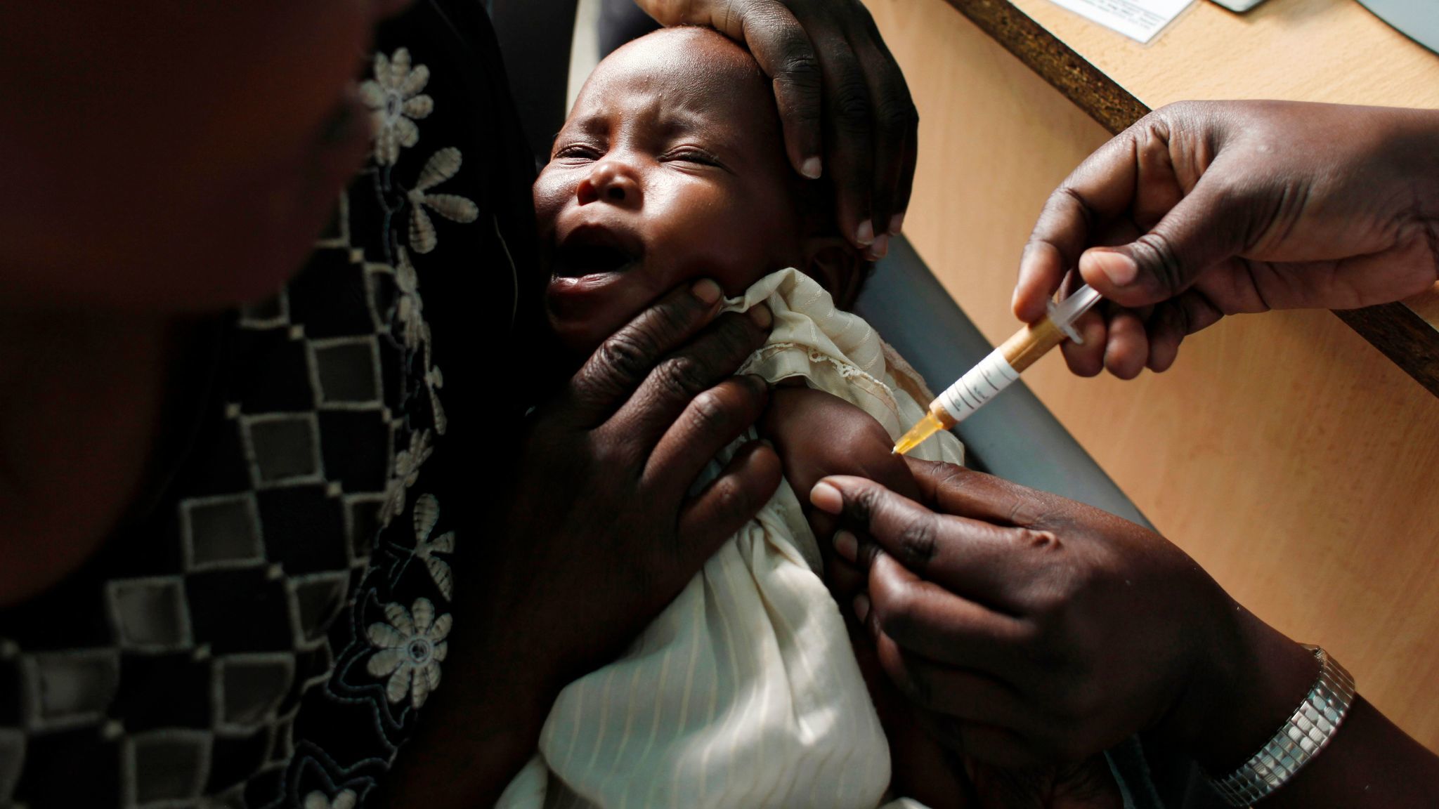 A baby in Kenya receives a malaria vaccine.