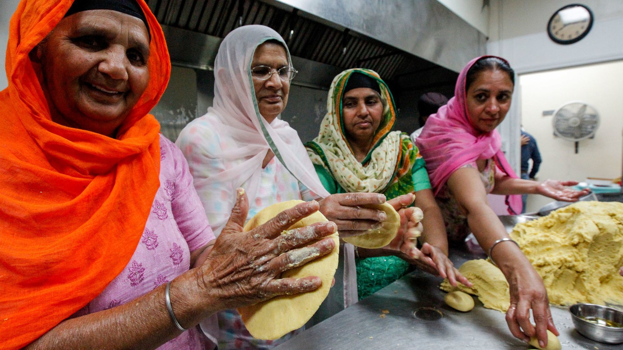 Sikh women prepare bread during Nagar Kirtan celebrations at Gurdwara Guru Angad Darbar in Bakersfield.