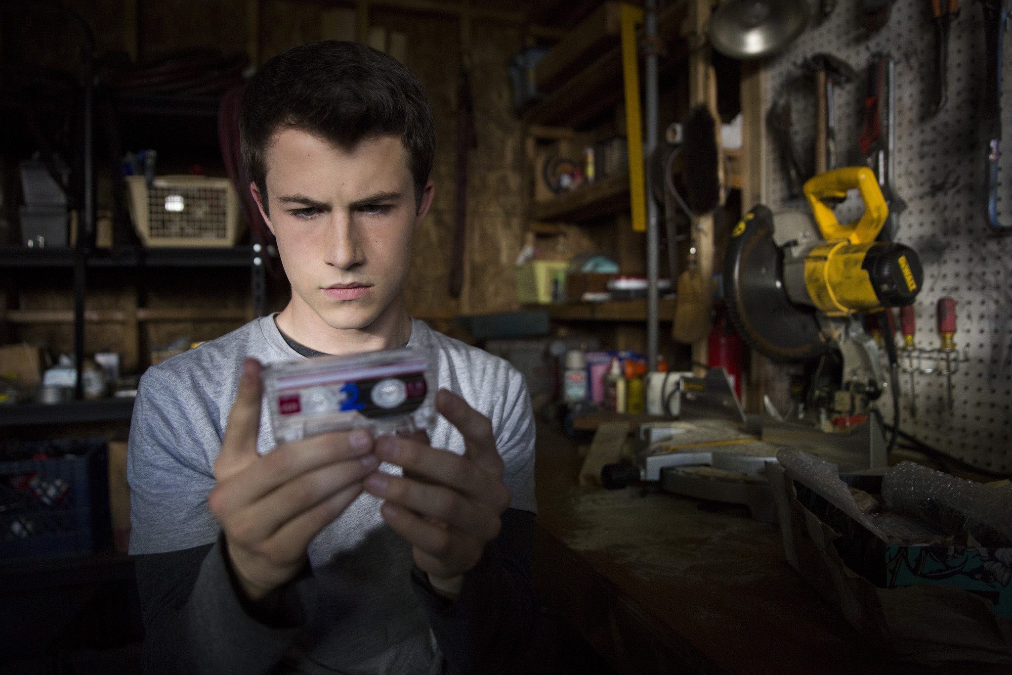 Dylan Minnette (playing Clay Jensen) listen to the tapes of deceased character Hannah Baker on "13 Reasons Why."