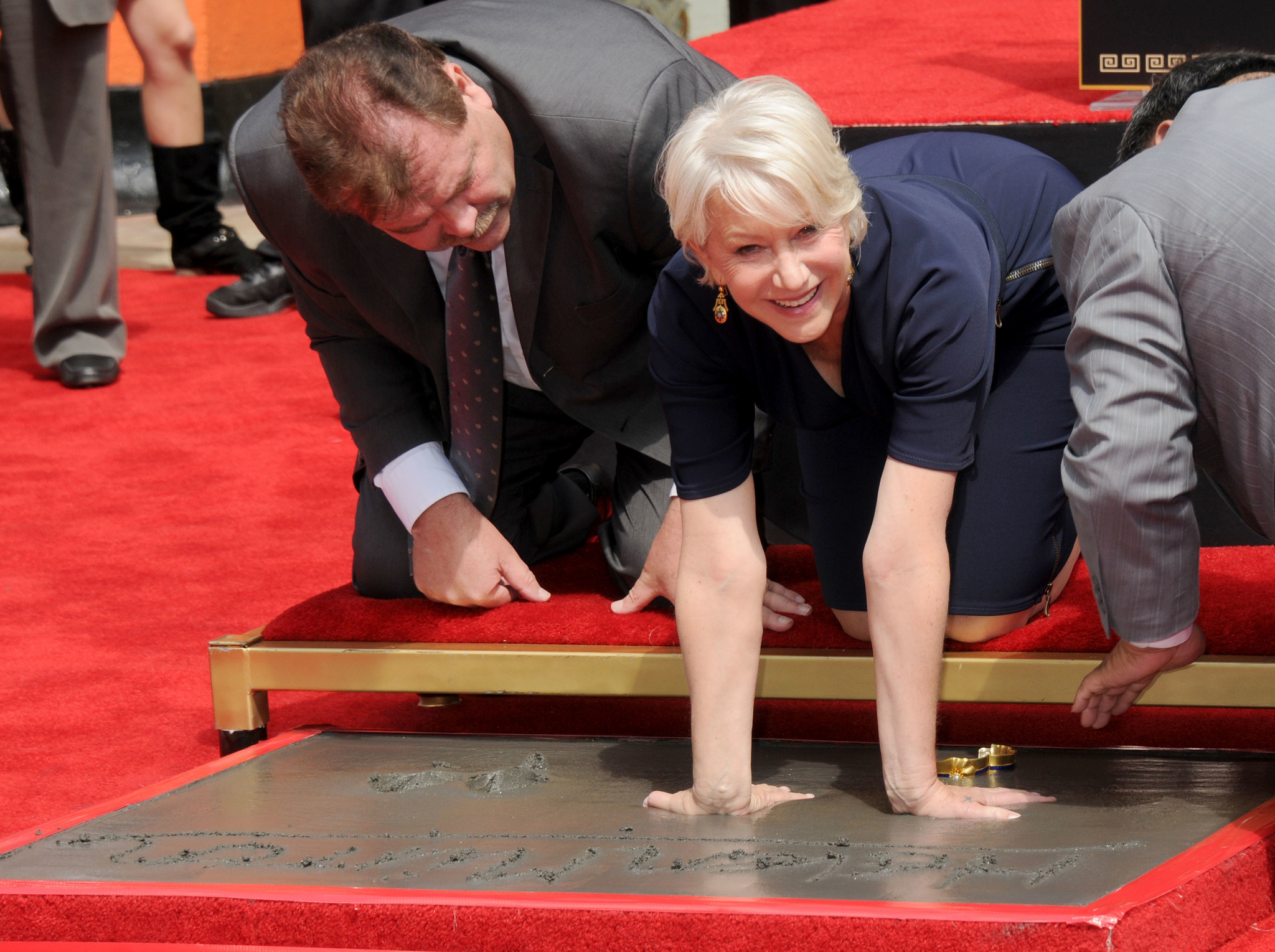 Helen Mirren gets her hand and footprints immortalized in cement at Grauman's Chinese Theatre on March 28, 2011 in Hollywood.