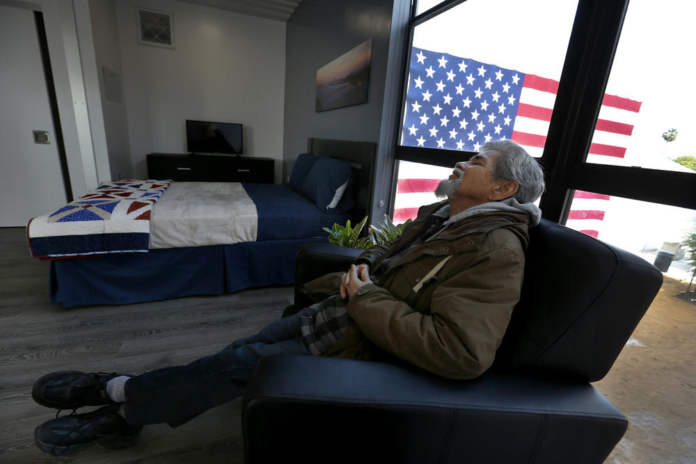 After the grand opening crowds have left, homeless Army veteran Kenneth Salazar, 60, relaxes in a new chair in his new studio apartment.