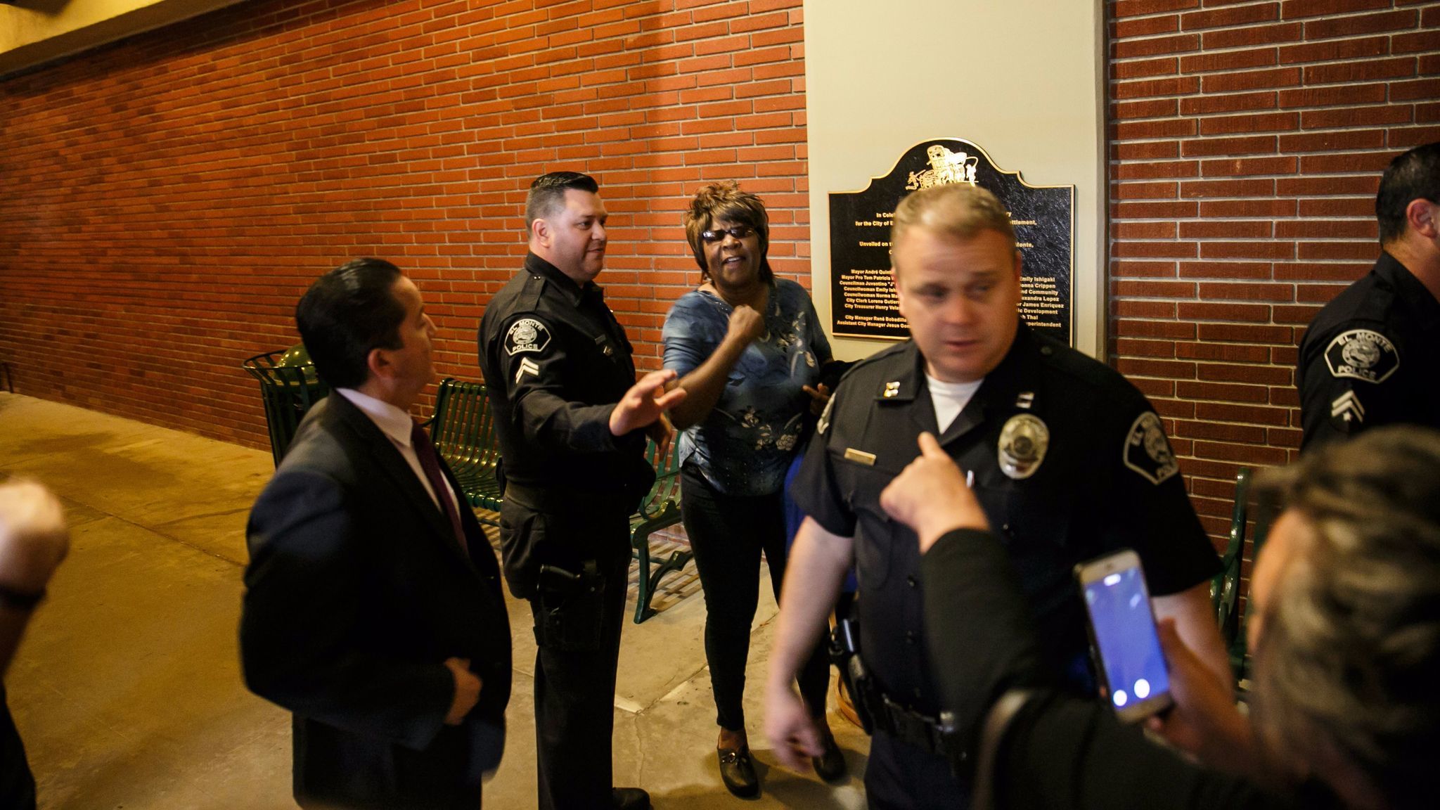 Chanell Temple is pulled aside by police after a brief scuffle broke out outside an El Monte City Council meeting on May 3. Pointing at her is El Monte resident Veronica Tomas, with back to camera.