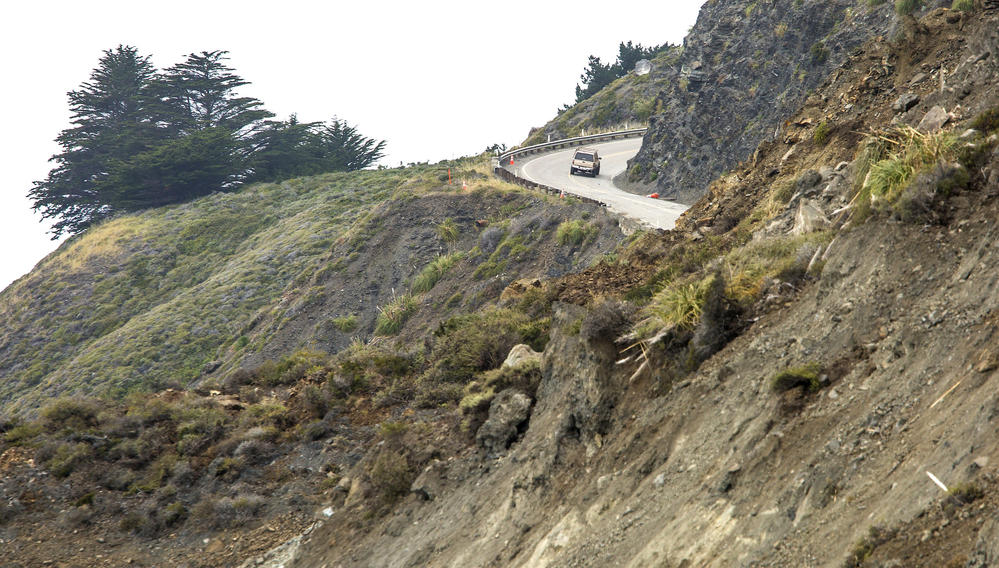 A southbound motorist turns around after hitting a dead end on Highway 1, where a massive landslide cut off the road north of Ragged Point in Monterey County.