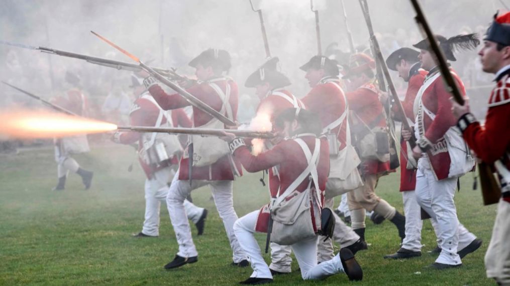 British troops fire on Continental Army soldiers during a Patriots' Day reenactment of the battles of Lexington and Concord, in Lexington, Mass.