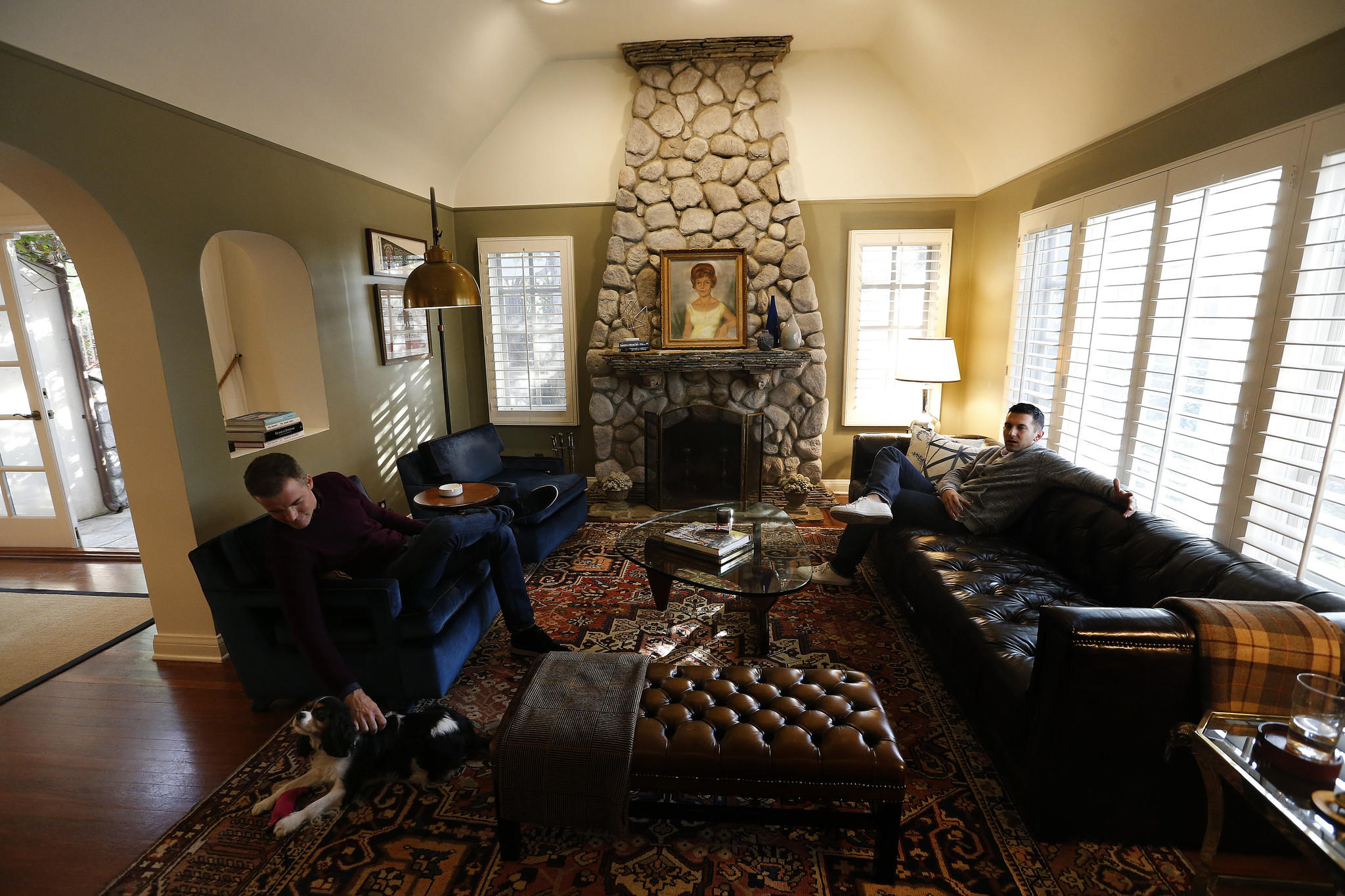 Patrick Wildnauer, left, and his husband Tom Balamaci,  sit inside the living room of their English cottage style home.