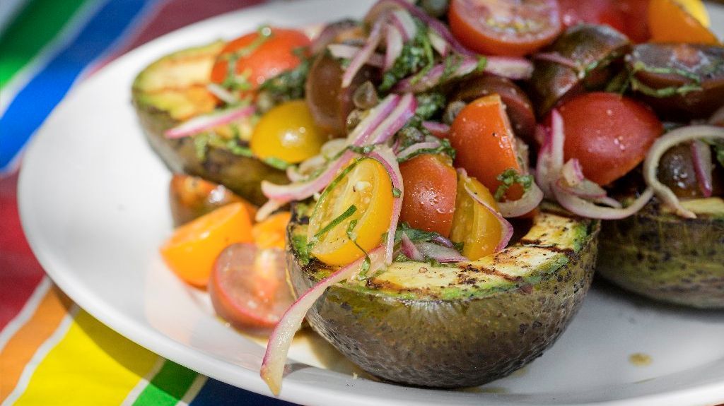 Grilled avocado with marinated tomato salad.