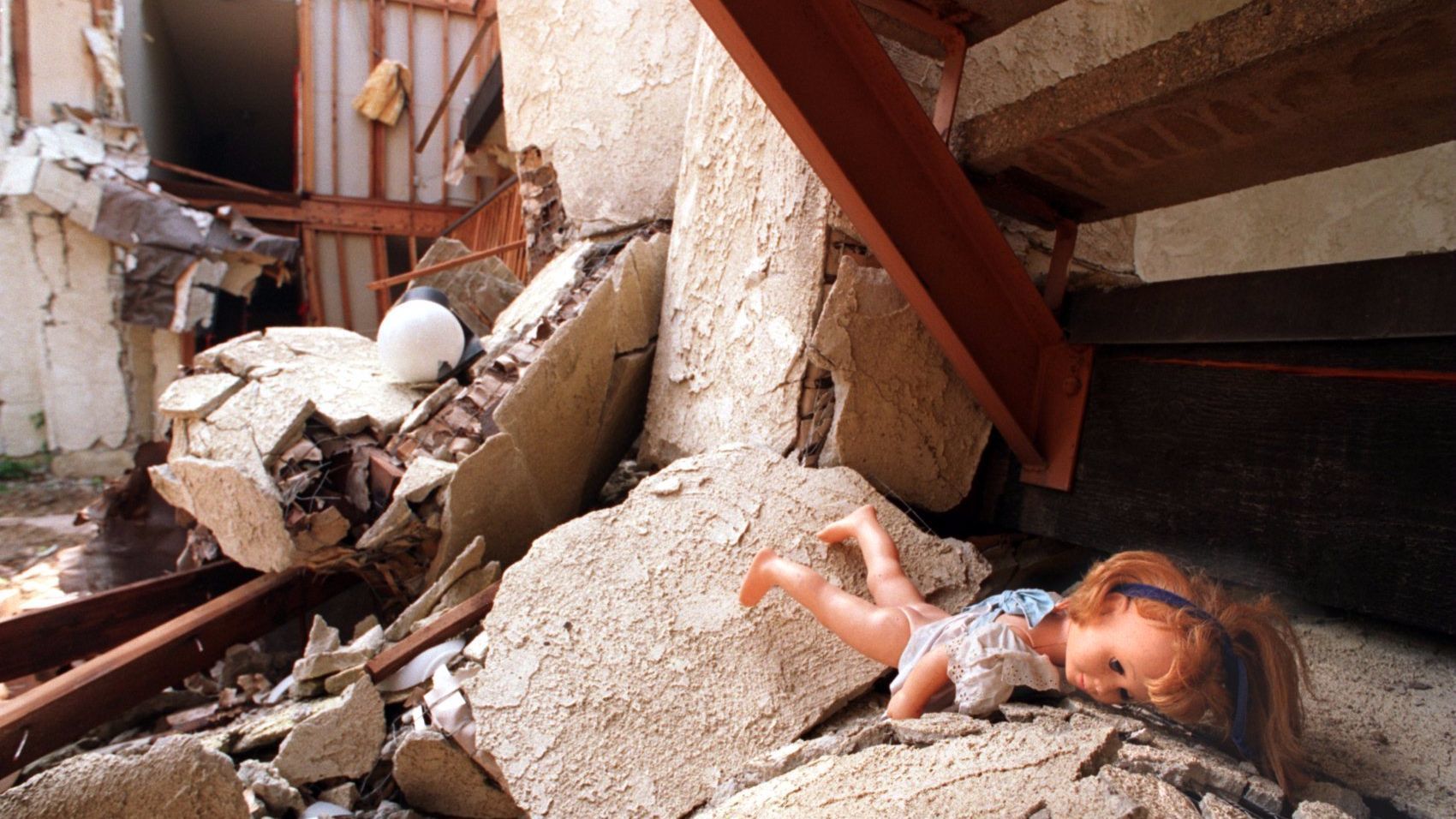A doll lies in the rubble of the Northridge Meadows apartment, where 16 bodies were found after 1994 Northridge earthquake.