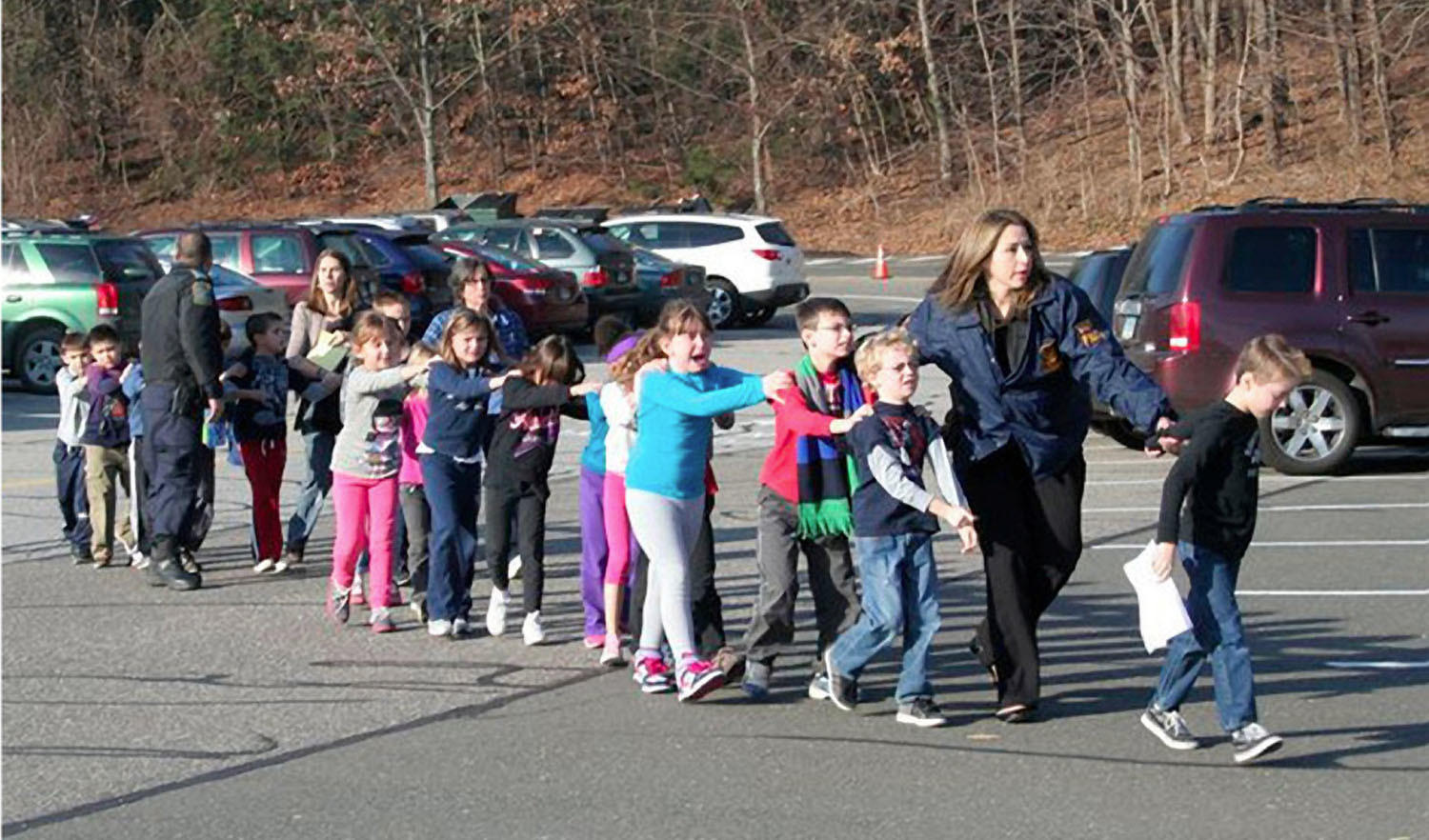 State police personnel lead children from the Sandy Hook Elementary School in Newtown, Conn.