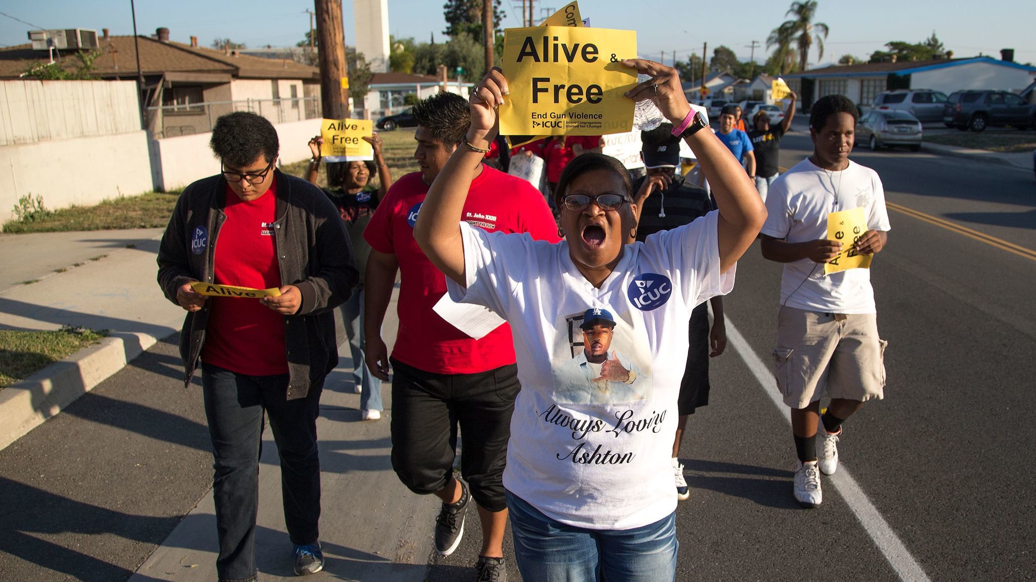 Sandra Hall of San Bernardino marches with about 200 community members in a Peace Walk to honor the victims of homicides and call for an end to gun violence on May 19, 2016, in San Bernardino.