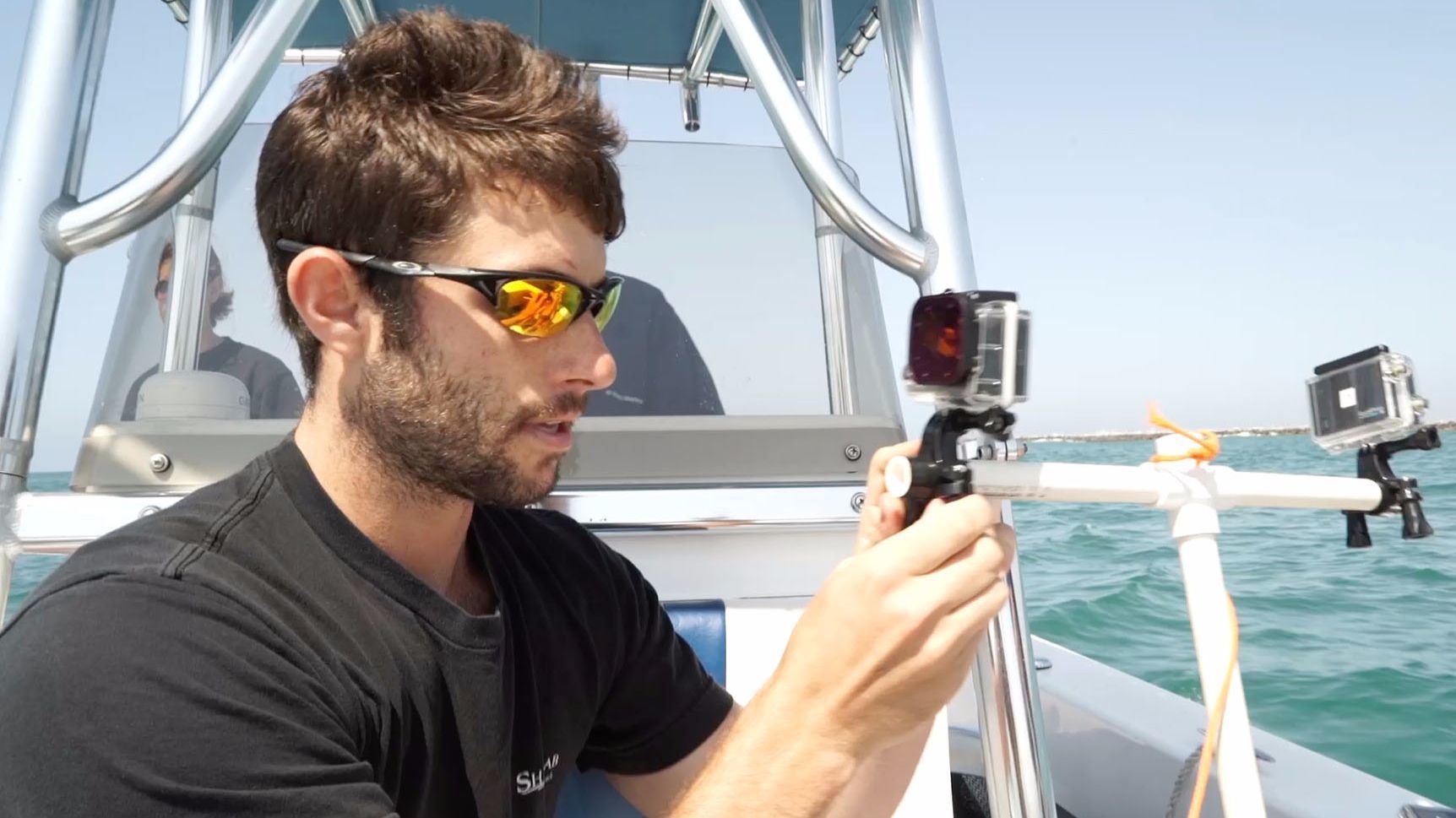 Dan Crear at graduate student in biology at Long Beach State adjusts the GoPro camera set up before submerging it.