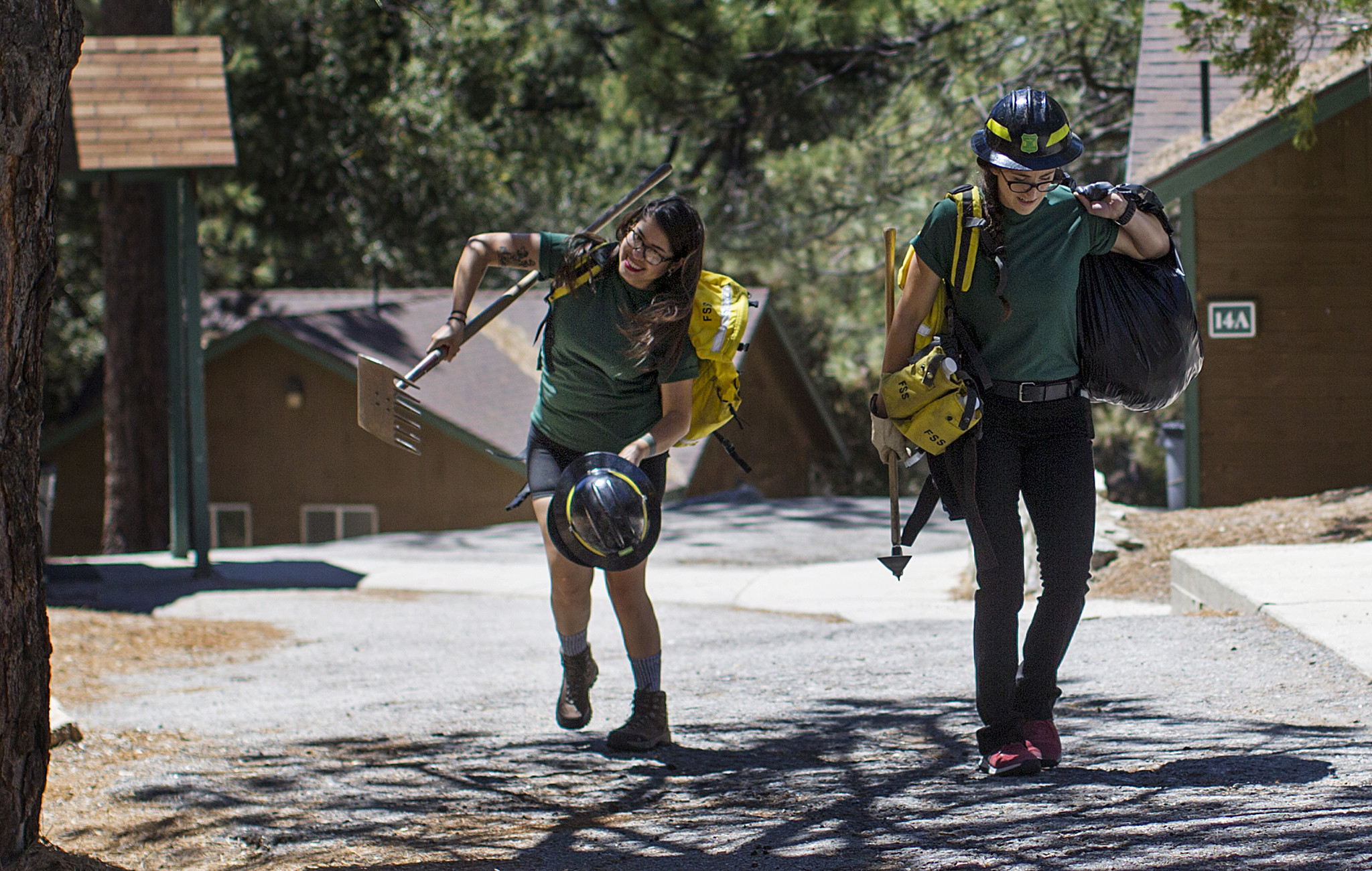 L.A. art teacher Estephany Campos, left, and Inglewood sales clerk Kelsey Almendariz pack up their hand tools after graduating from the Women in Wildland Fire Basic Training Camp.