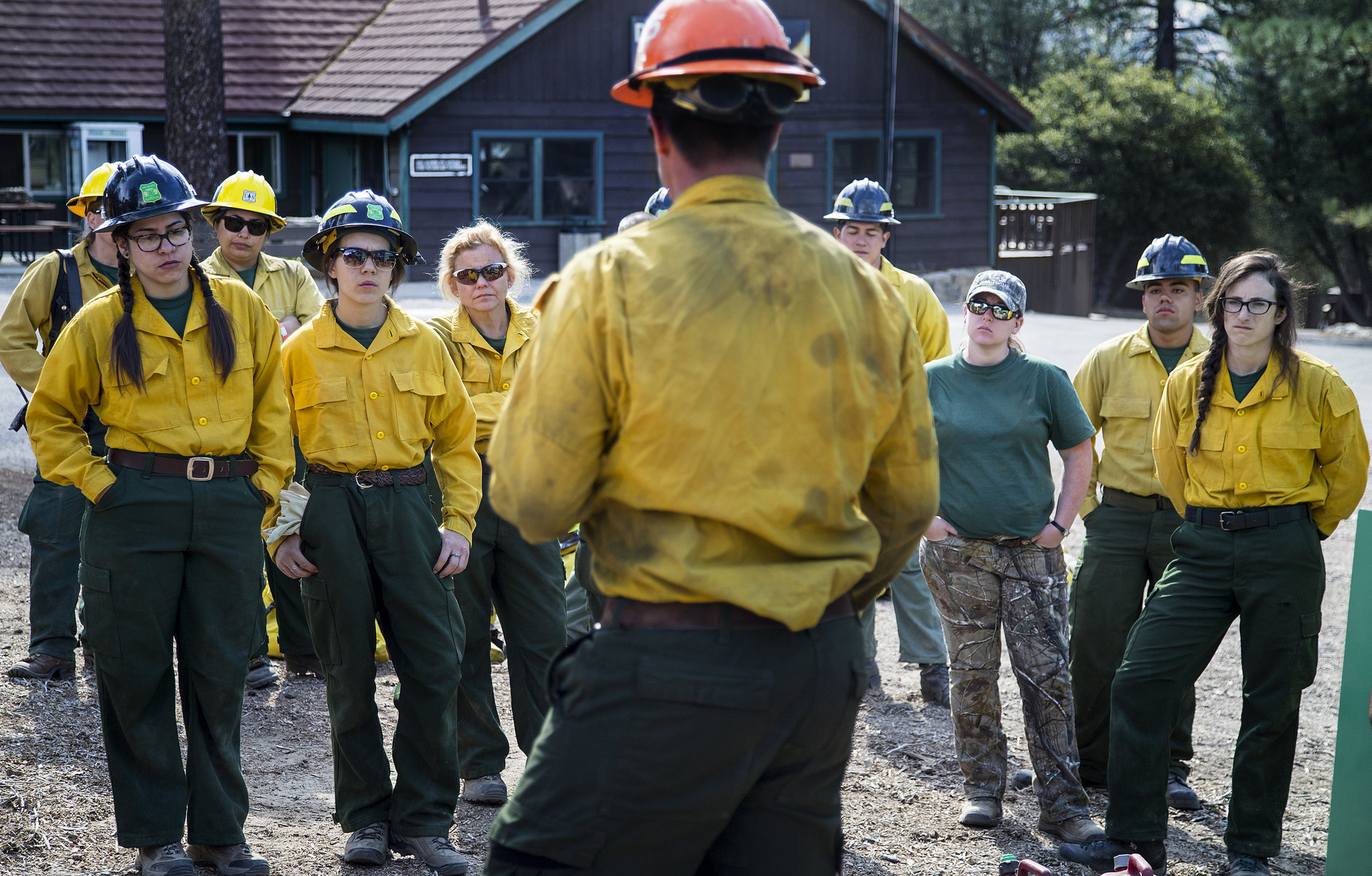 A firefighter from the U.S. Forest Service talks to the trainees about communications equipment and incendiary devices.