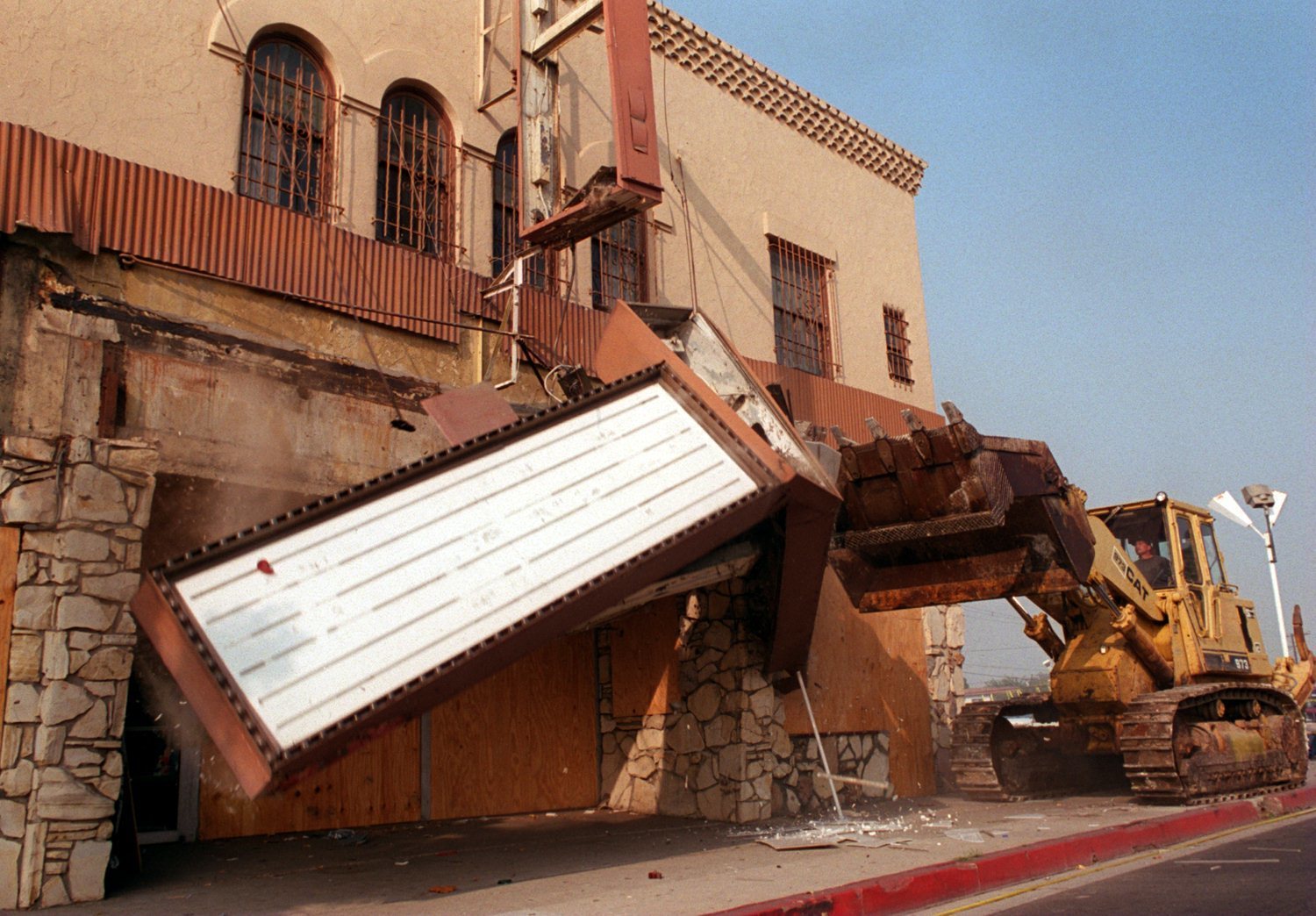A bulldozer knocks down the marquee of the Pussycat Theater in Buena Park in 1995 after years of legal challenges.