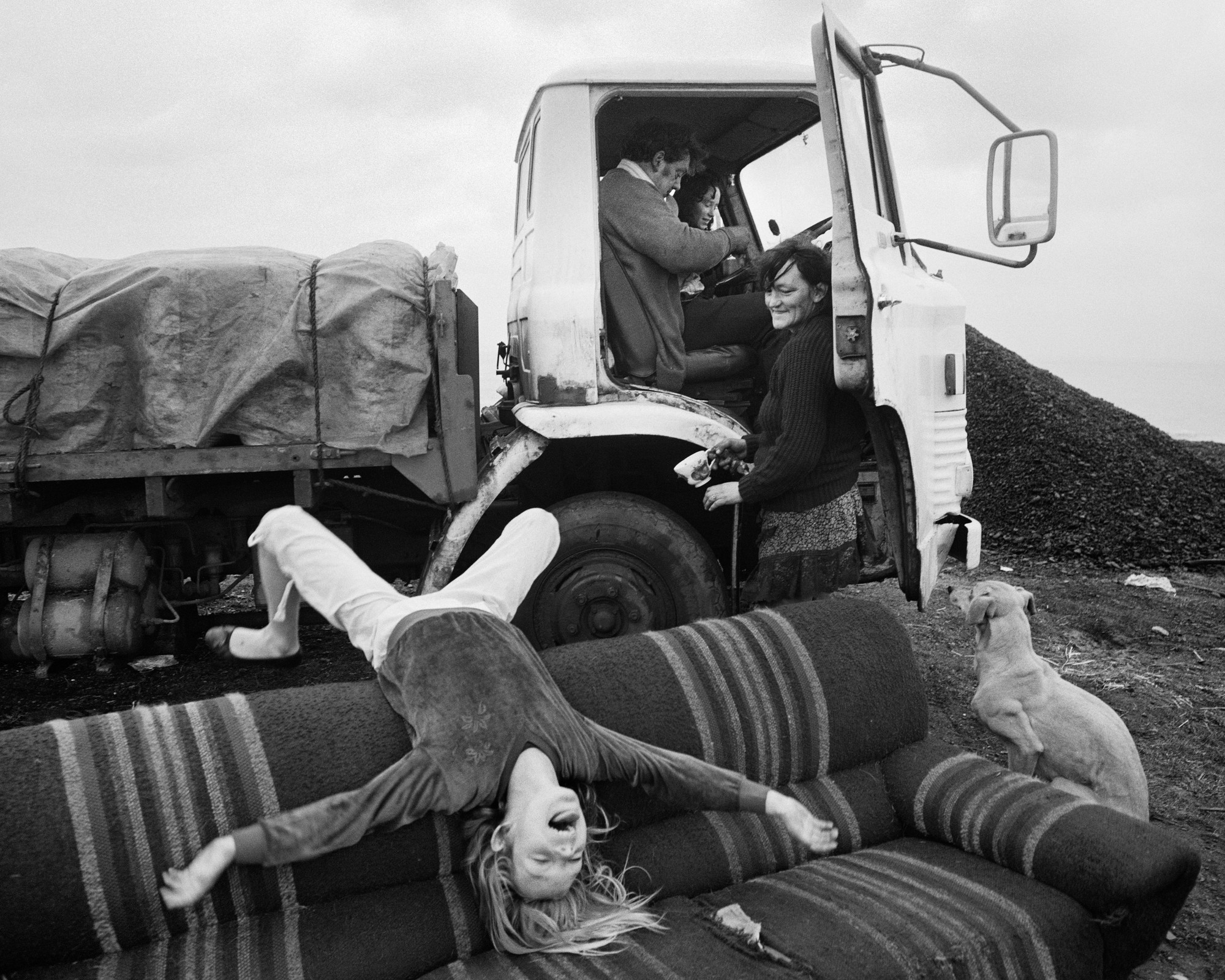 "Helen (upside down), Brian, Alison and Rosie, Seacoal Camp, Lynemouth, Northumberland," 1983, by Chris Killip.