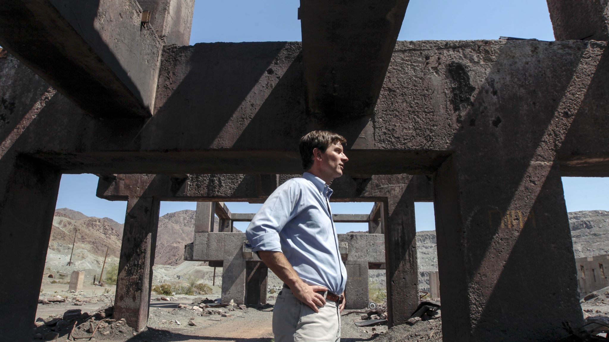 Steve Lowe, president of Eagle Crest Energy Co., stands amid the ruins of the ore loading area.