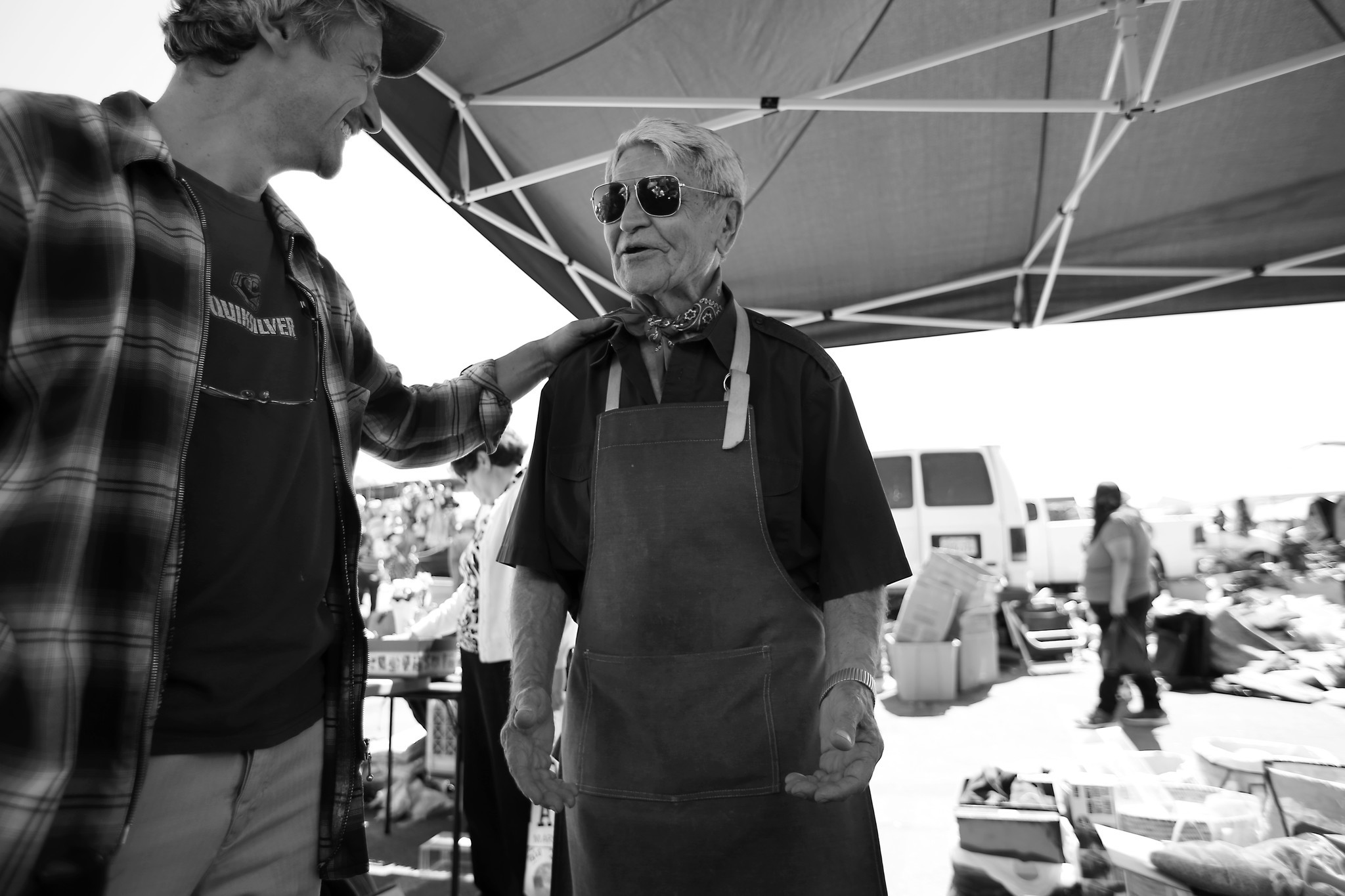 Jozsi Baky, left, helps Steve Hideg at the Alpine Village Swap Meet in Torrance to sell some of his
