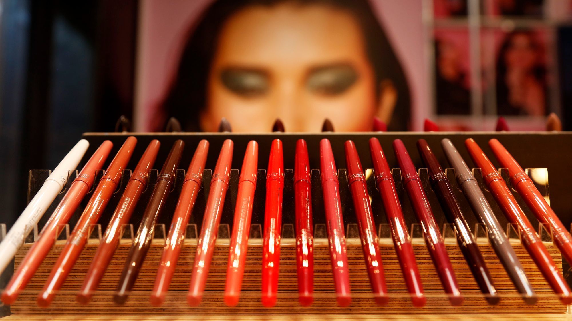 A photograph of a model peers behind a row of eyeliner pens inside the new Smashbox store in Venice.