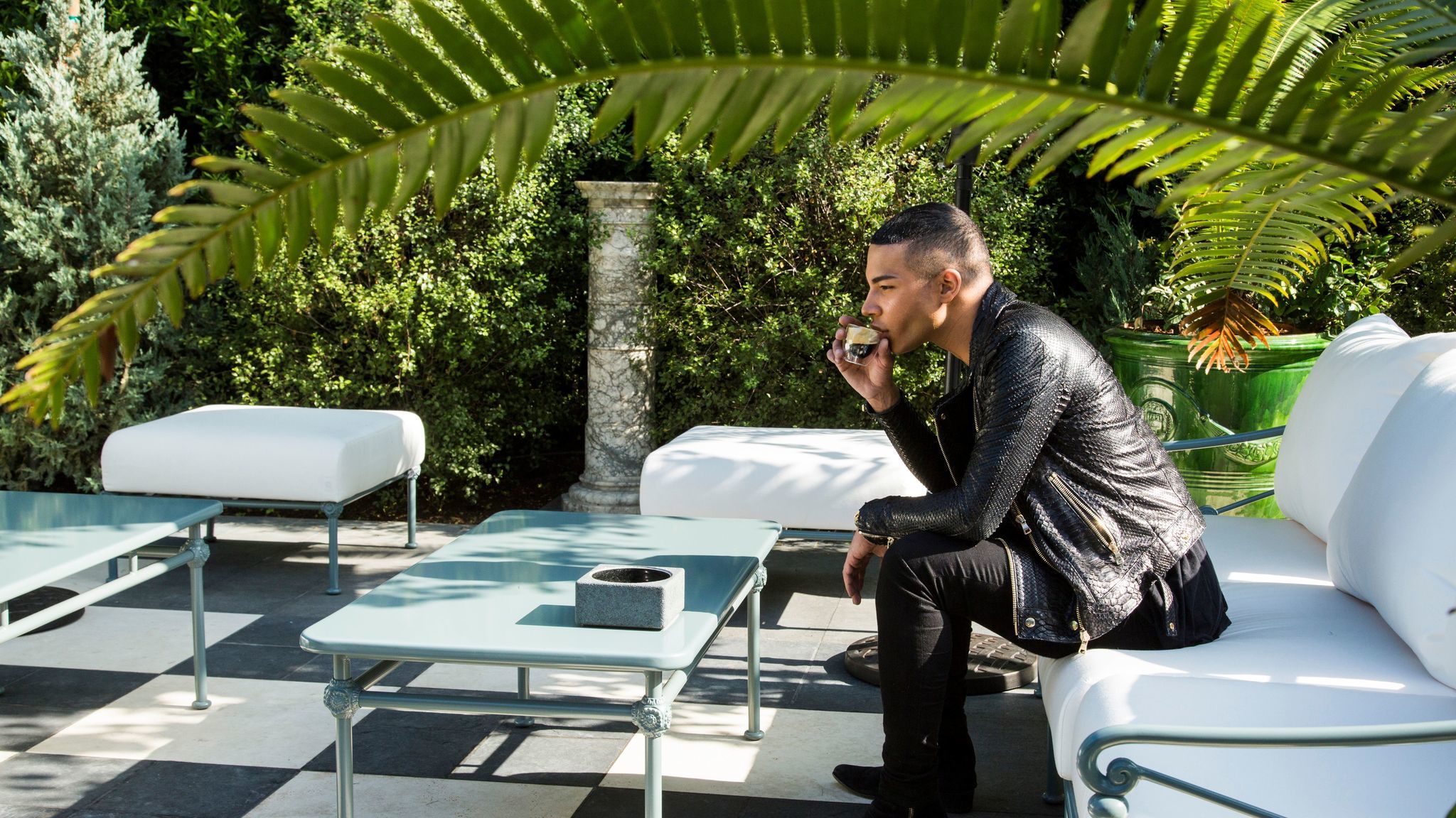 Rousteing taking a break in the outside garden at Balmain's new flagship store in Los Angeles.