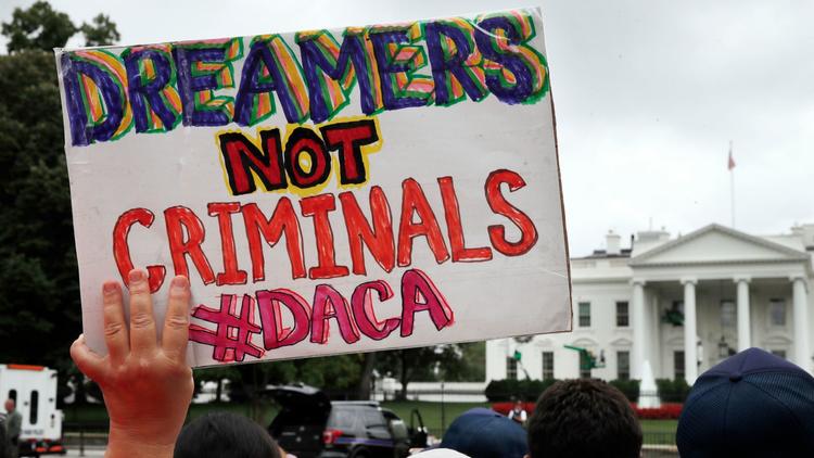 A woman holds a sign in support of the Obama administration program known as Deferred Action for Childhood Arrivals, or DACA, during an immigration reform rally on Aug. 15, 2017, at the White House. (Jacquelyn Martin / Associated Press)
