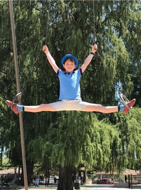 Iain Armitage playing on the gymnastic rings at Beeman Park in Studio City.