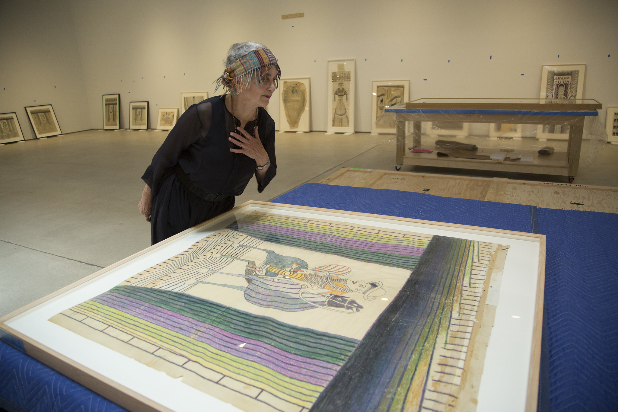 Elsa Longhauser looking at one of the works by Martín Ramírez.