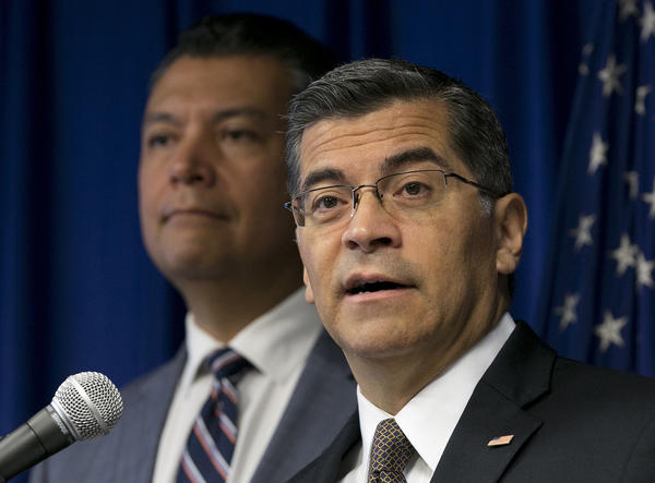California Atty. Gen. Xavier Becerra, right, speaks at a news conference Tuesday with Secretary of State Alex Padilla. (Rich Pedroncelli / Associated Press)