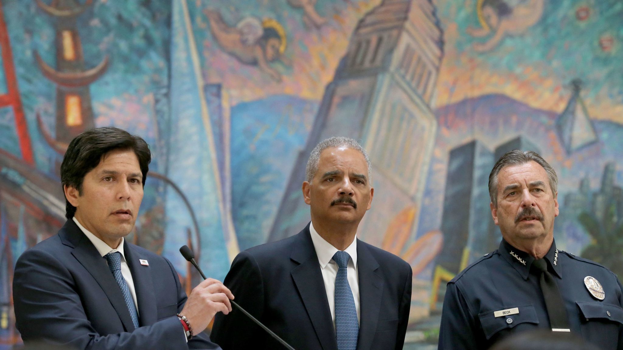 Senate leader Kevin de León, left, answers questions during a news conference to address the so-called sanctuary state bill while Former U.S. Atty. Gen. Eric Holder, center, and LAPD Chief Charlie Beck listen.