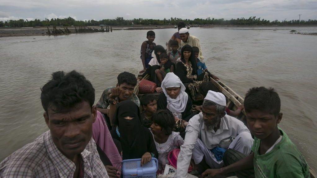 Rohingya refugees cross into the mainland after arriving in Bangladesh.