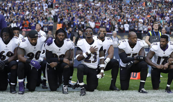 Baltimore Ravens players kneel in protest during the national anthem at Wembley Stadium in London on Sept. 24.