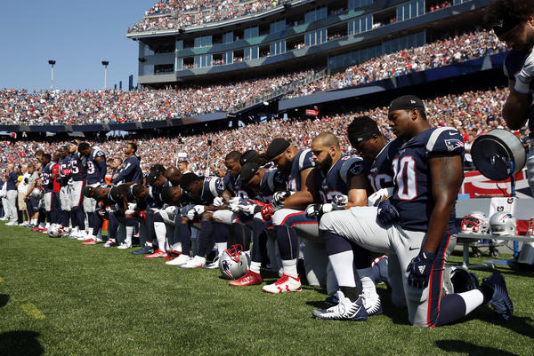 Several New England Patriots players kneel during the national anthem before a Sept. 24 game against the Houston Texans in Foxborough, Mass.