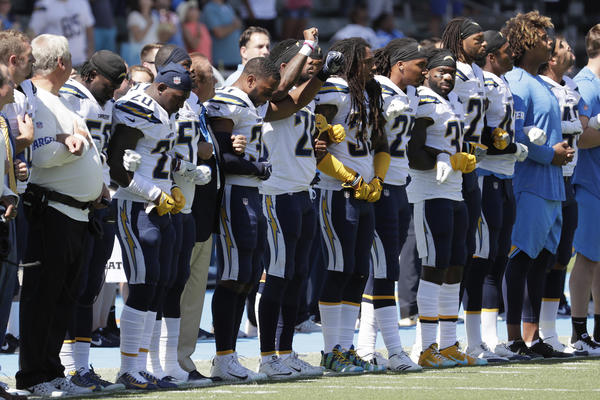 The San Diego Chargers link arms during the national anthem in a game against the Kansas City Chiefs at StubHub Center.