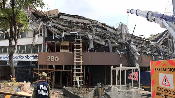The upper stories at this office building at Avenida Alvaro Obregon 286 in Mexico City have collapsed, leaving entire floors stacked like pancakes.