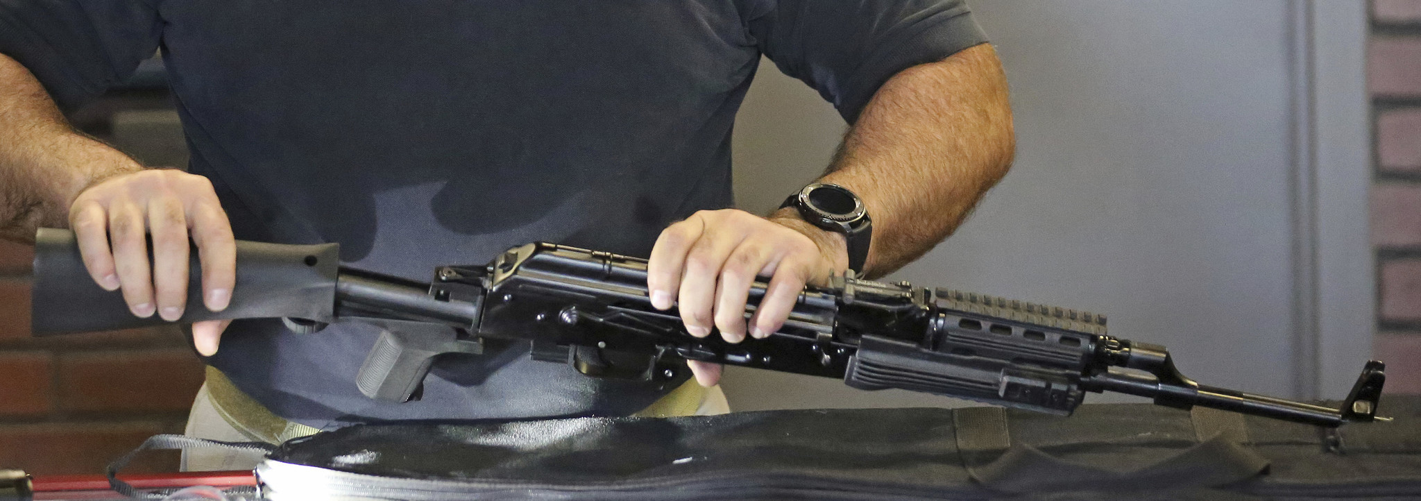 Clark Aposhian, chairman of the Utah Shooting Sports Council, demonstrates attaching a "bump stock" to a semiautomatic rifle.
