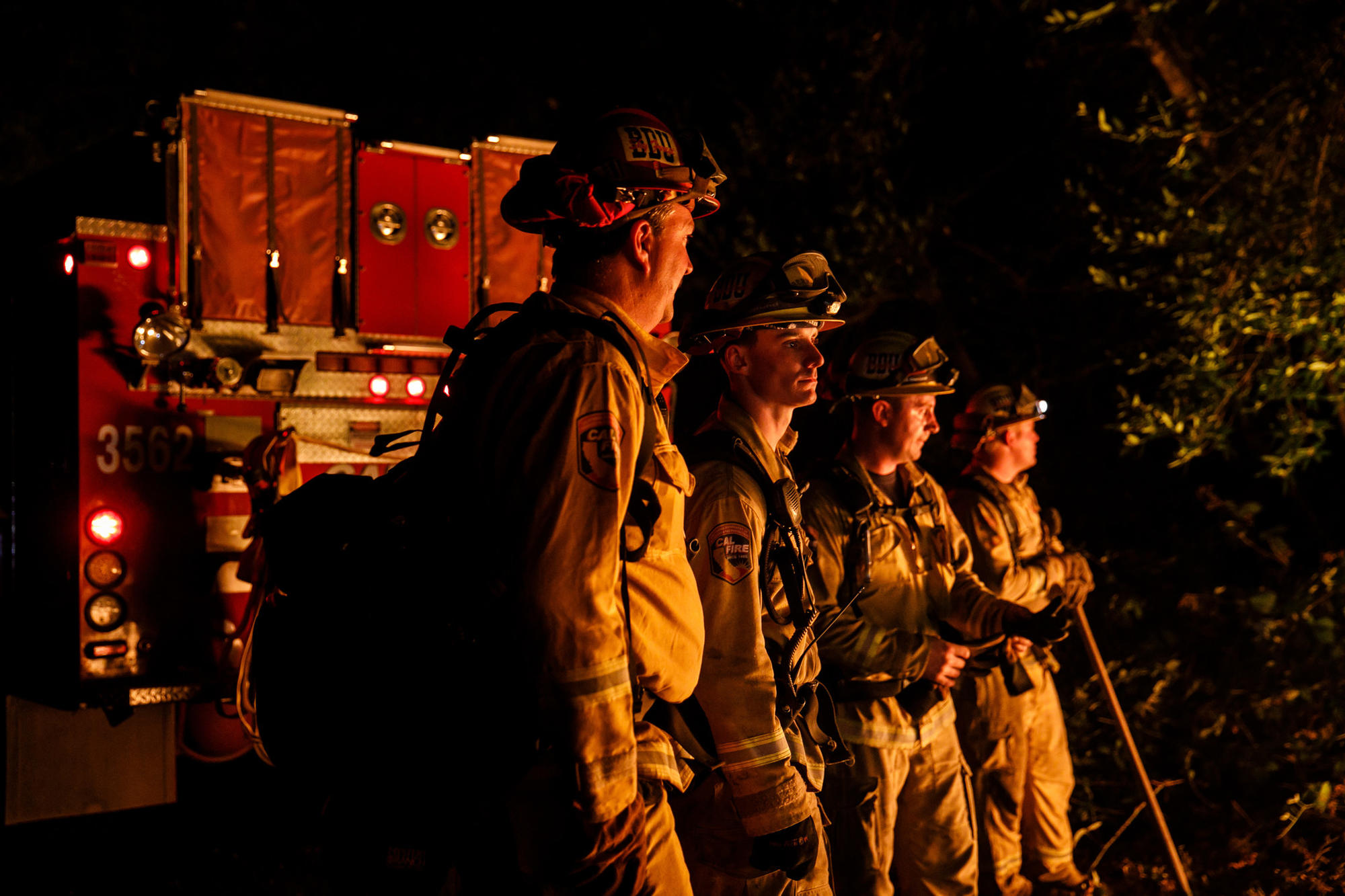 From left, firefighters Gary Mattingly, Tim Zanotelli, Brandon Tolp and Devon Elenburg, all based in San Bernardino, stand ready to swing into action along Highway 29 north of Calistoga on Oct. 12.