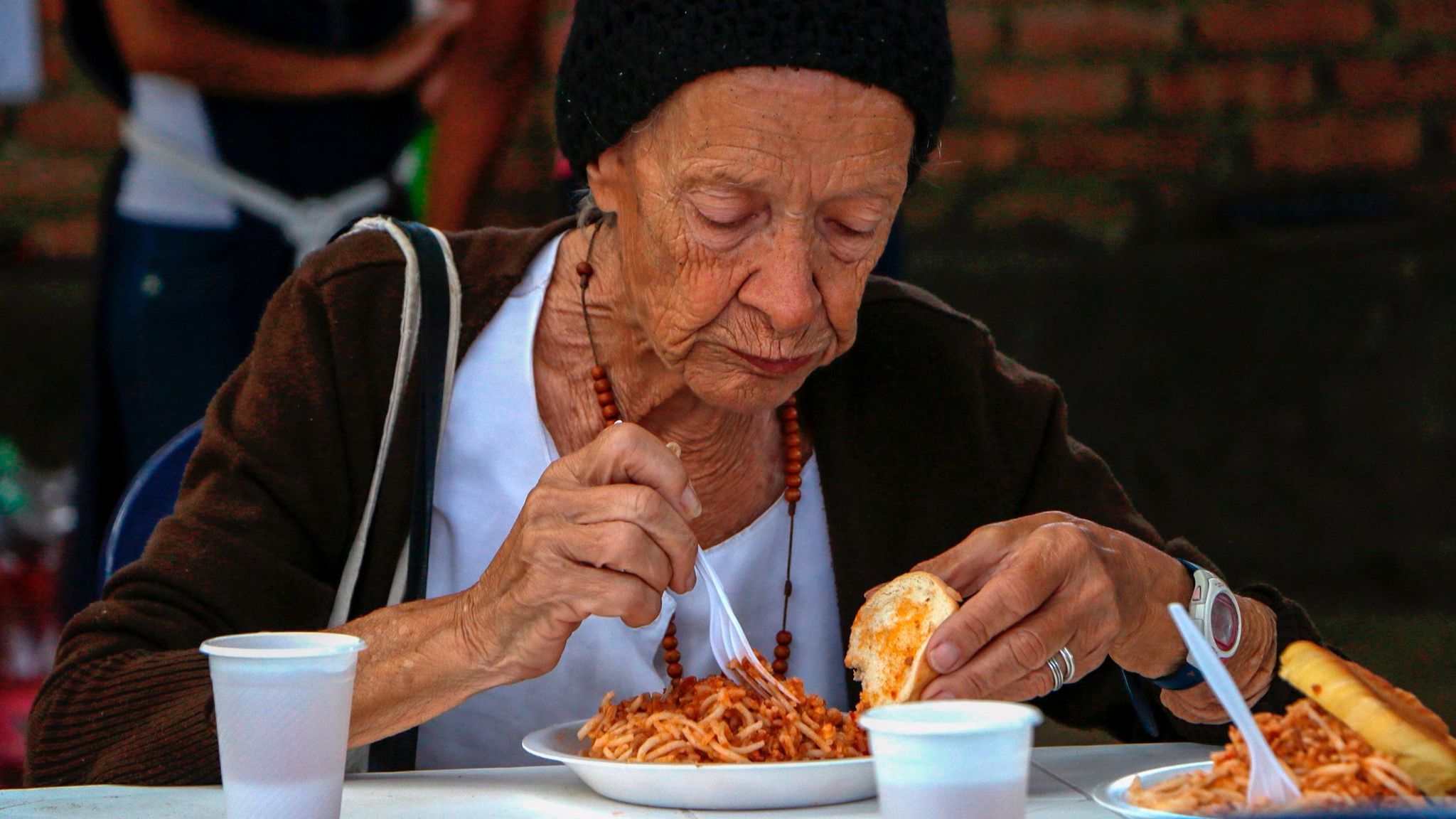 Venezuelans get food at the Casa de Paso Divina Providencia refuge in Cucuta, Colombia in July.
