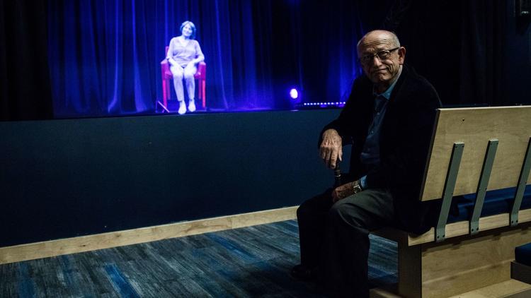 Holocaust survivor Sam Harris looks at a holographic image of Holocaust survivor Fritzie Fritzshall