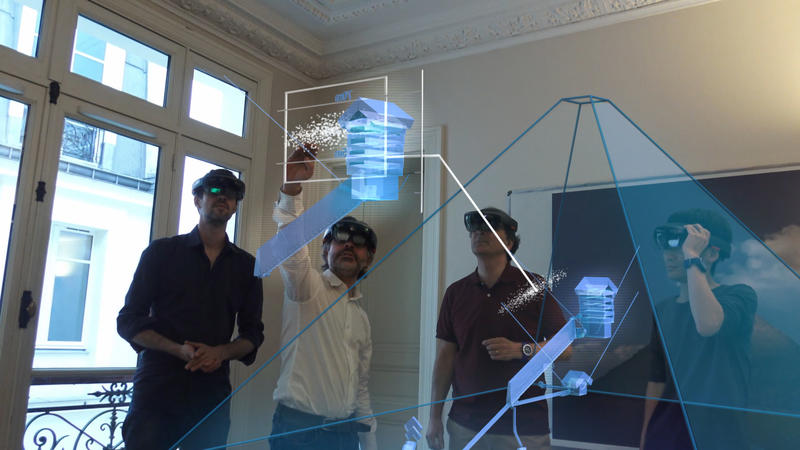 Members of the research team use augmented reality to visualize the pyramid's void.