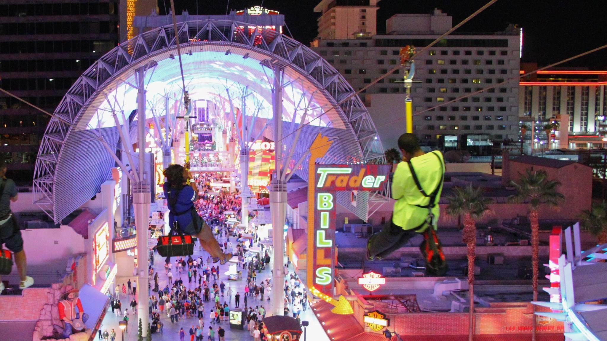 Riders soar above the crowds under the Fremont Street canopy during the Slotzilla experience in downtown Las Vegas.