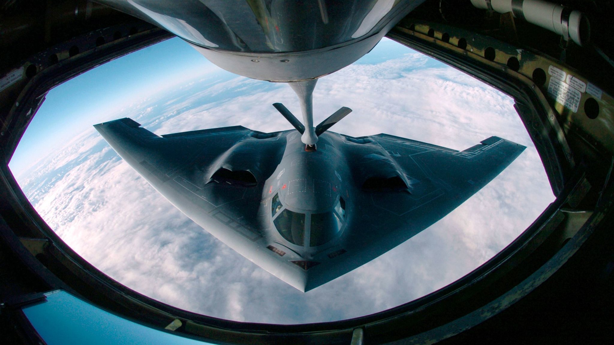 A B-2 bomber refueling from a KC-135 Stratotanker over the Pacific Ocean. The B-21 will be designed to be even stealthier than the B-2.