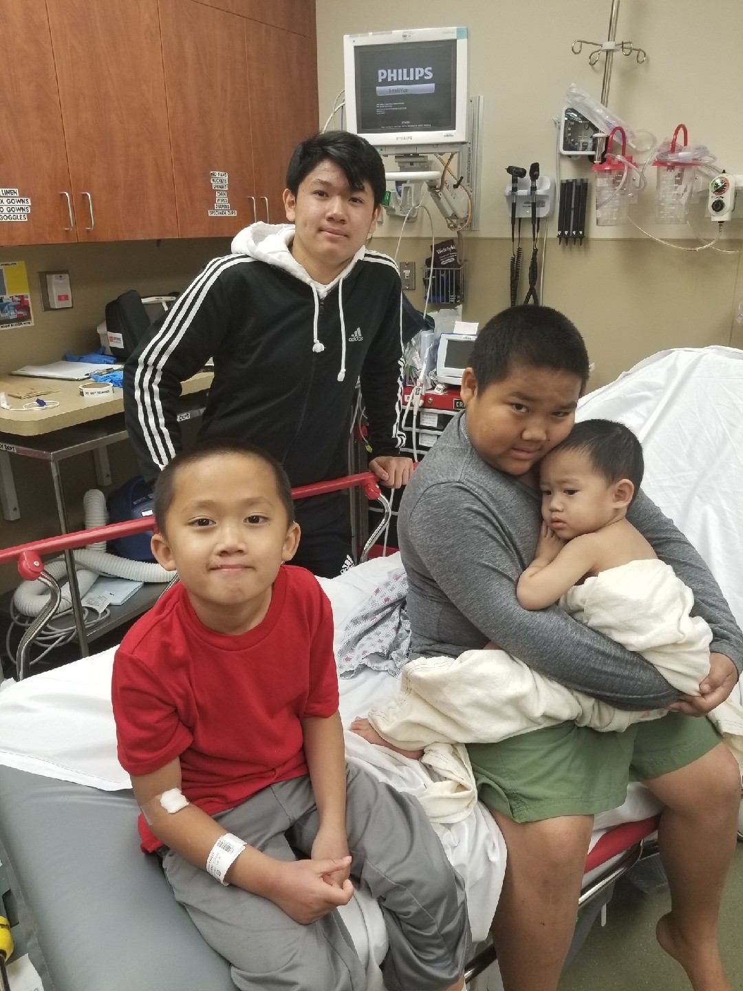 The Phommathep brothers of Rancho Tehama. Jake, 6, in the red shirt, was shot in the foot. John Jr.