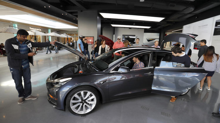 CENTURY CITY, CALIF. -- FRIDAY, JANUARY 12, 2018: People check out the Tesla Model 3, which starts a