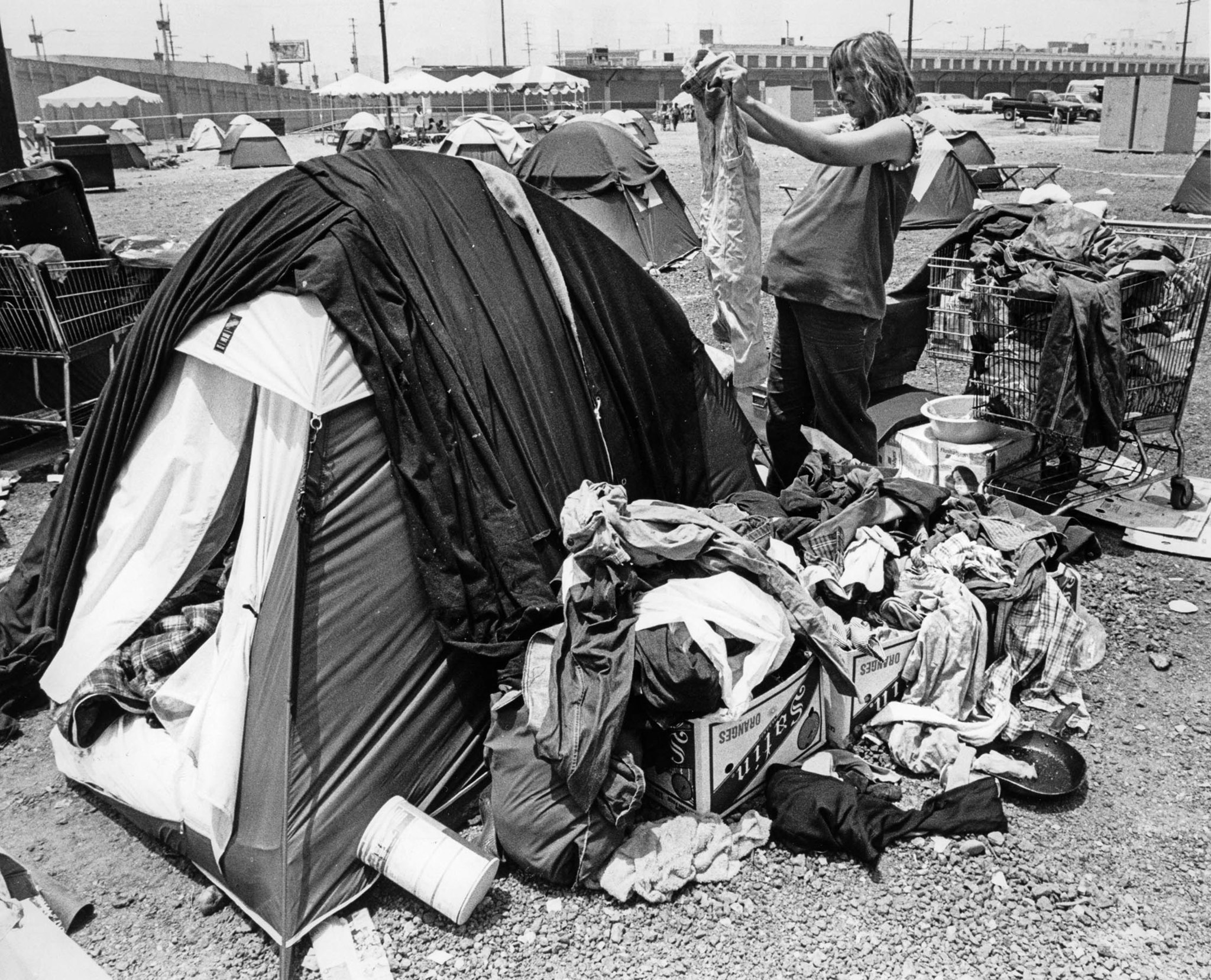 June 26, 1987: Lisa Gillie, 7 months pregnant, sorts clothes outside her tent at the Urban Campgroun