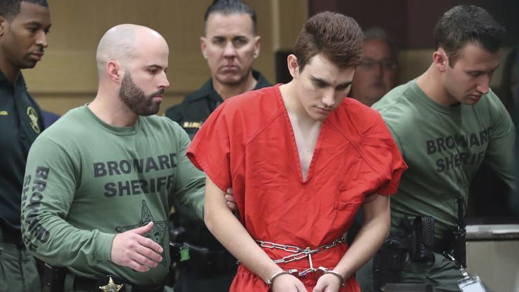 Nikolas Cruz is escorted into the courtroom for his arraignment at the Broward County Courthouse in Fort Lauderdale on Wednesday, March 14.