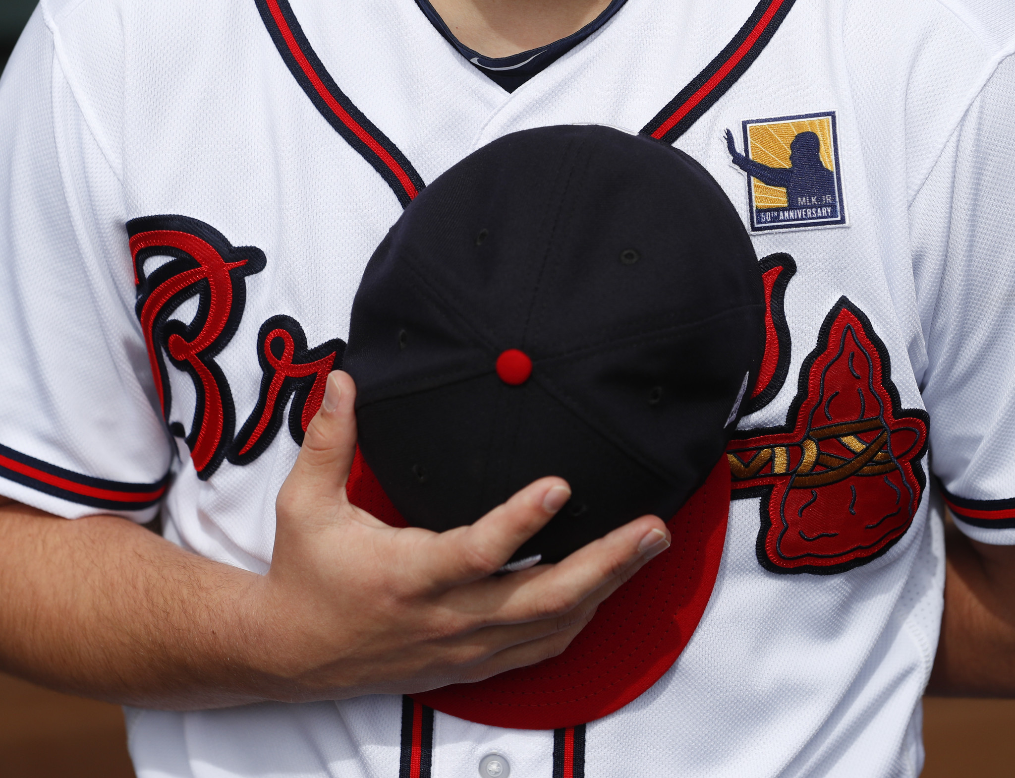 A member of the Braves staff wears a patch on his uniform marking the 50th anniversary of the death