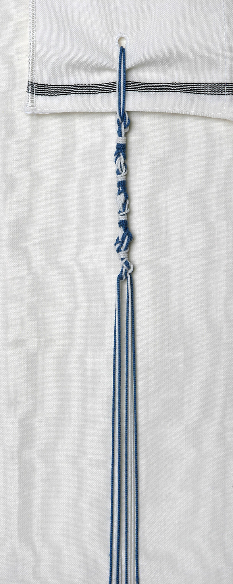Tzitzit tassels with threads dyed in tekhelet blue produced from Murex trunculus snails.
